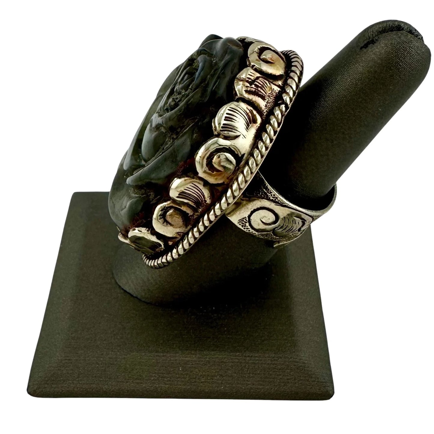 Decorative ring on a black stand with a white background