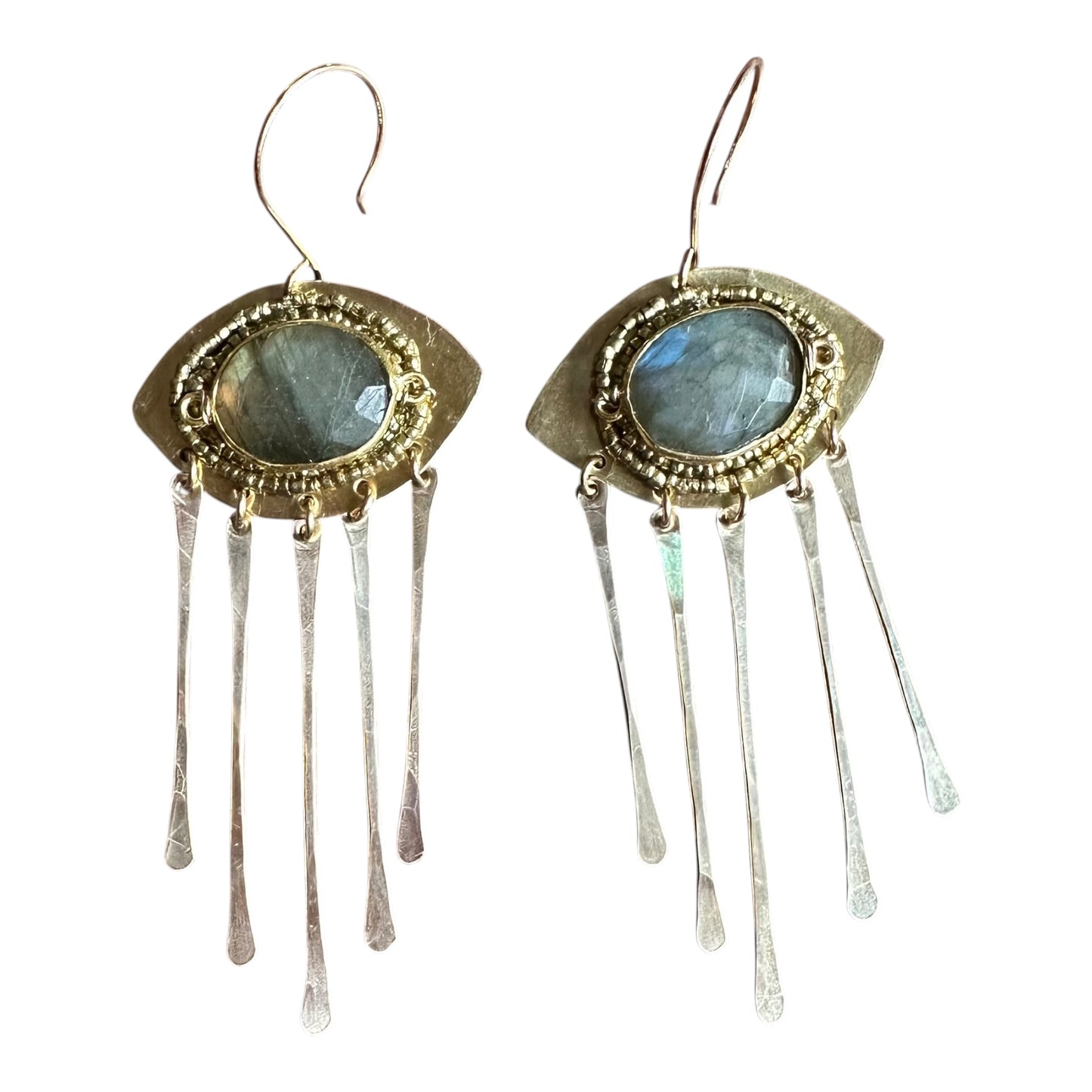 Pair of earrings with gold and silver design on a white background