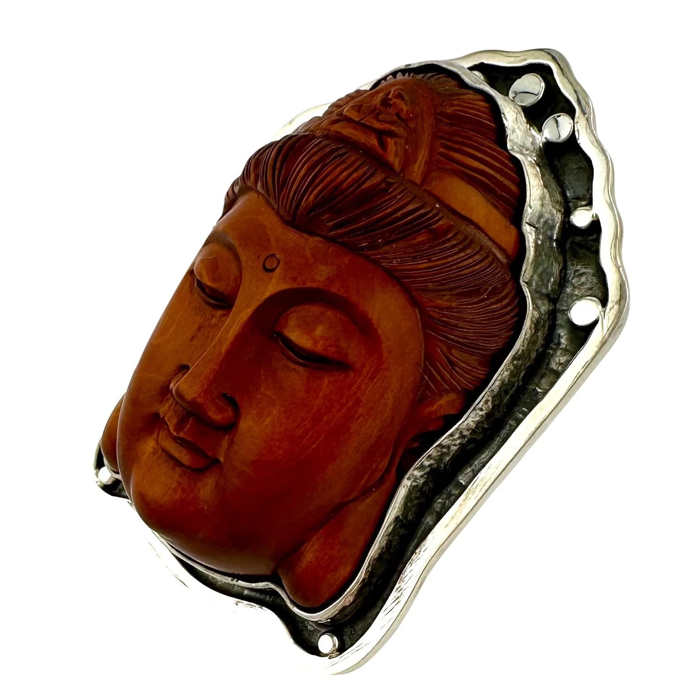 Carved stone pendant of a Buddha face with silver ring setting white background