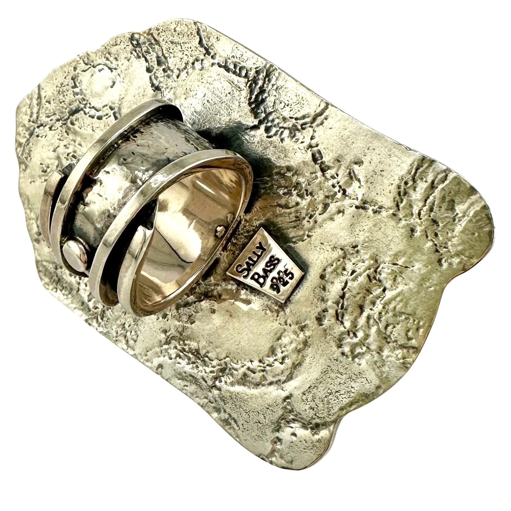 Silver handmade tooled back of Buddha ring with Sally Bass branding.