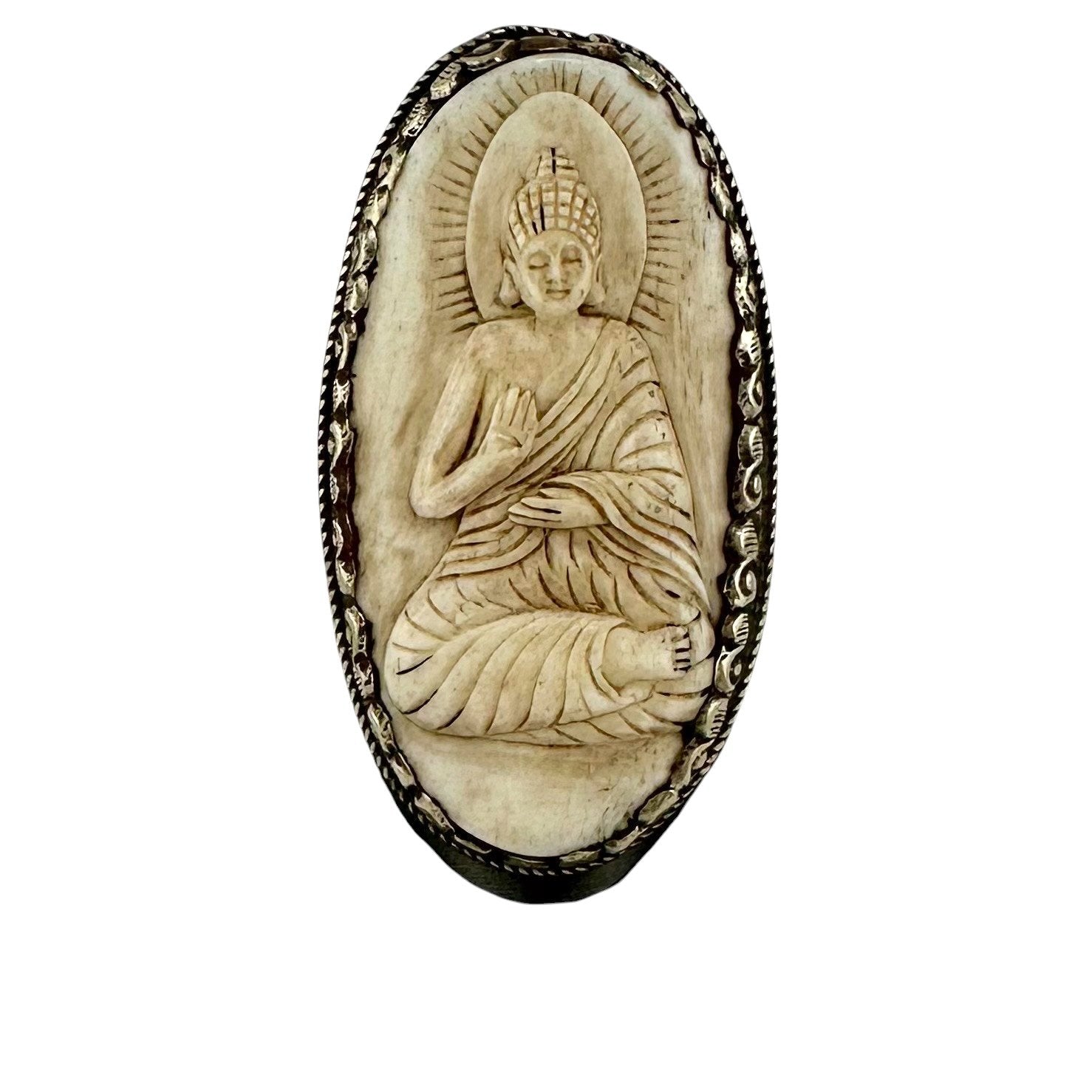 Carved stone plaque with a seated Buddha figure in a meditative pose on a white background