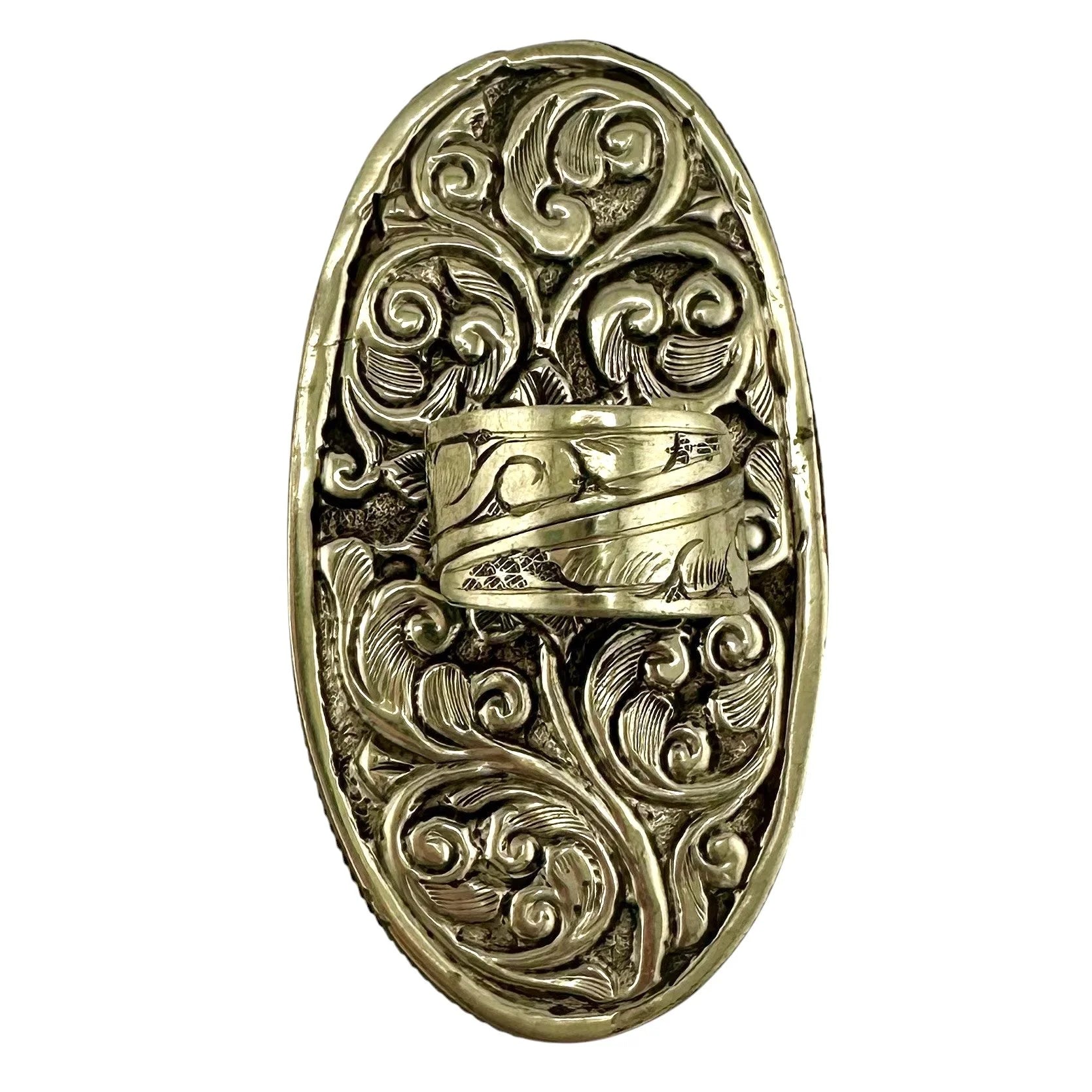 Rear view of a decorative silver ring with intricate designs on a white background