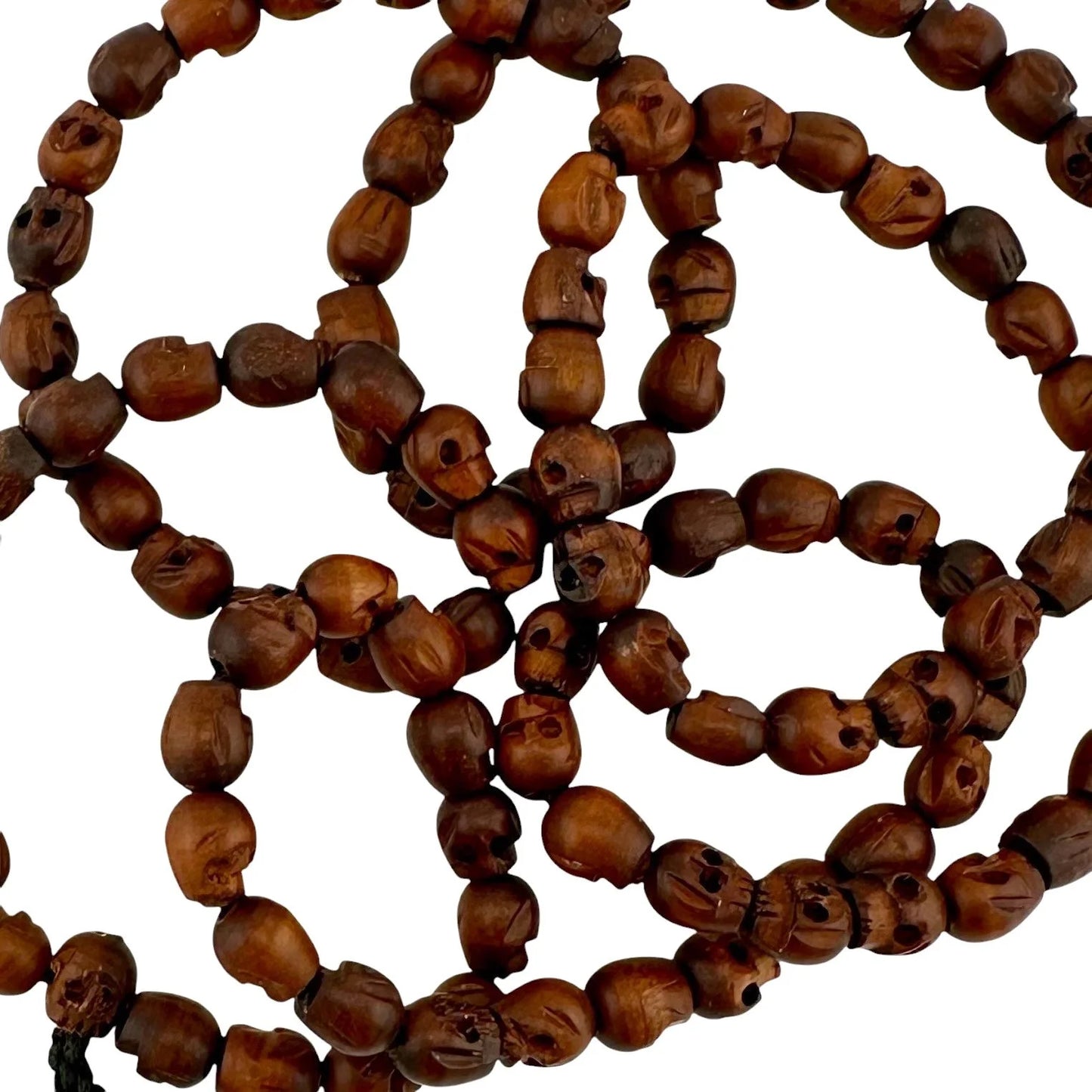 Wooden handmade beaded skull necklace with a tassel on a white background