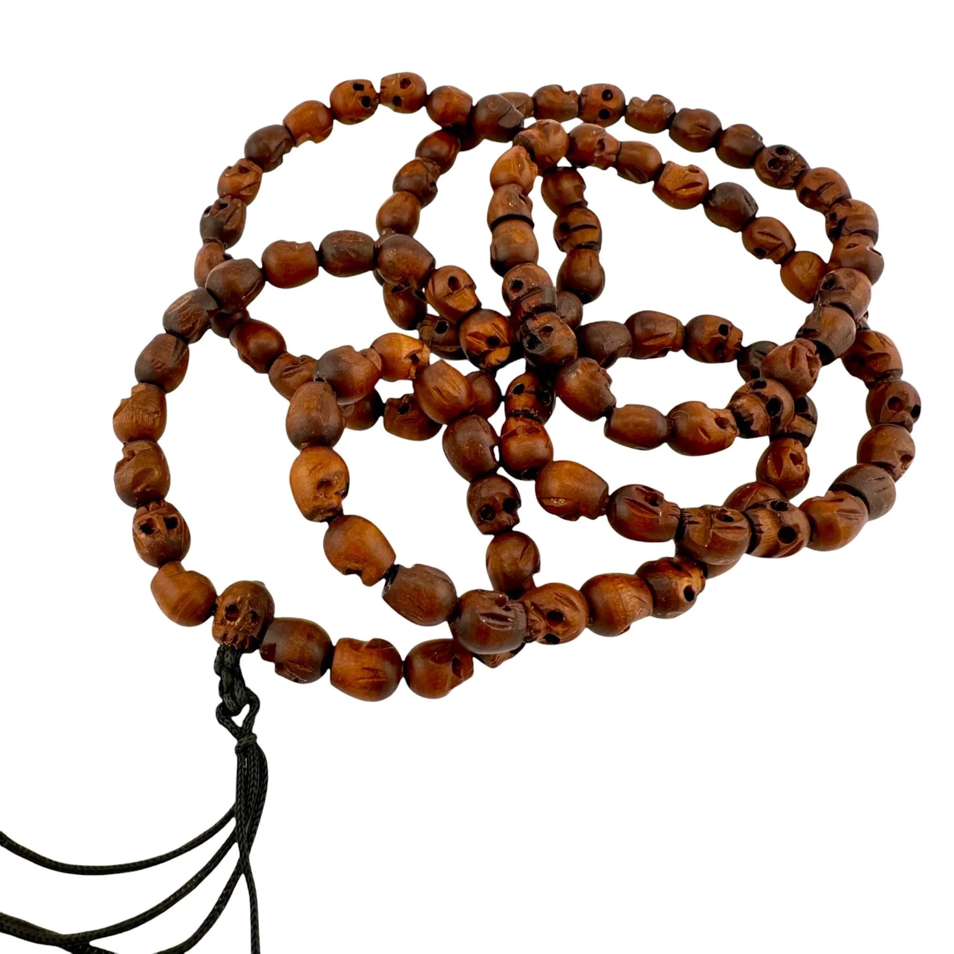 Wooden handmade beaded skull necklace with a tassel on a white background
