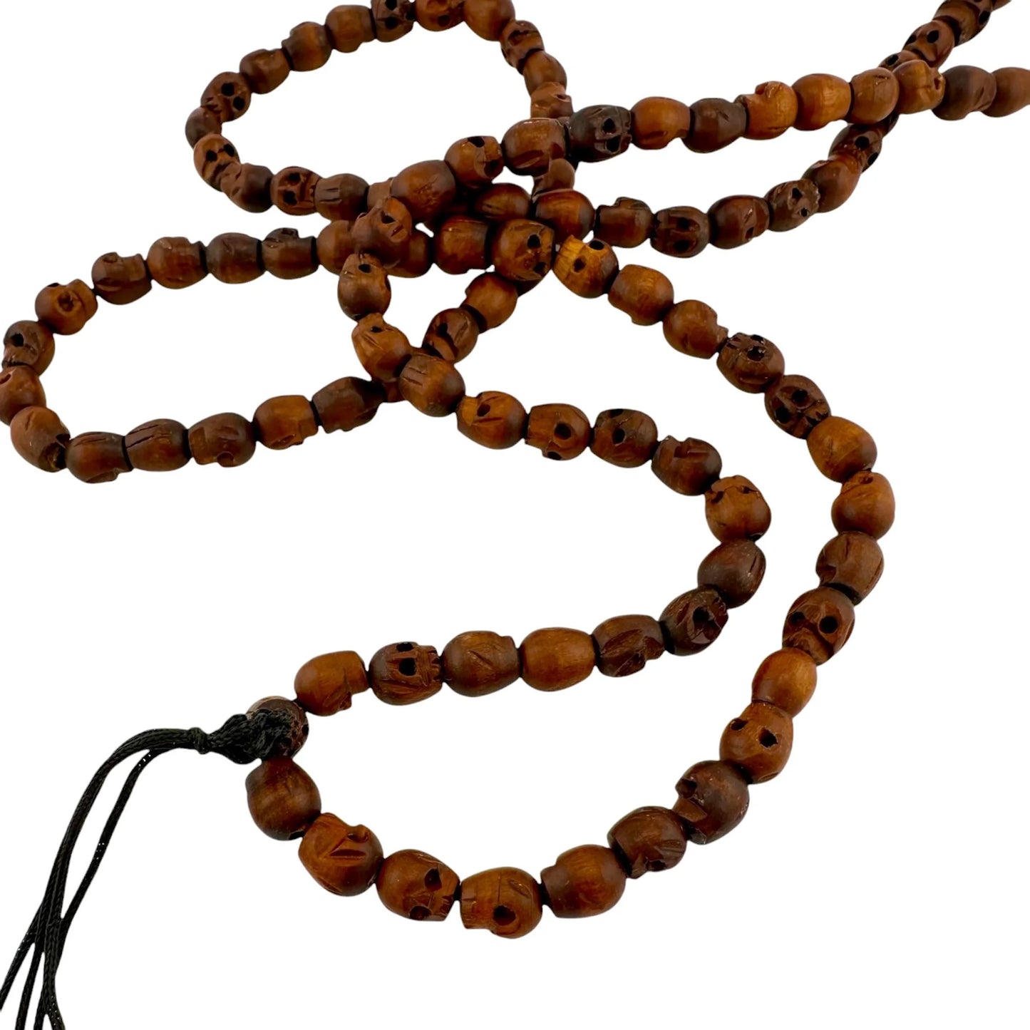 Wooden handmade beaded skull necklace with a tassel on a white background