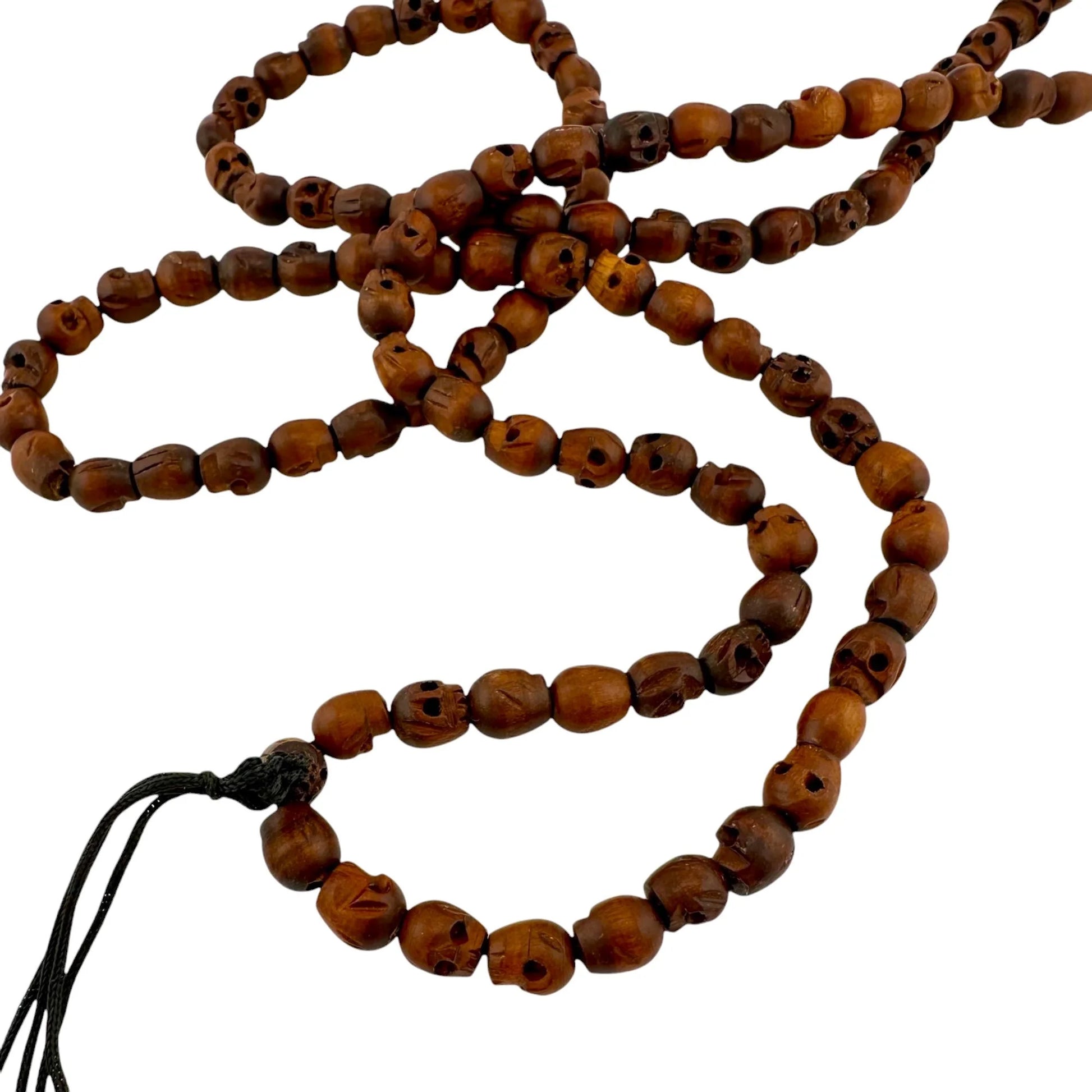 Wooden handmade beaded skull necklace with a tassel on a white background