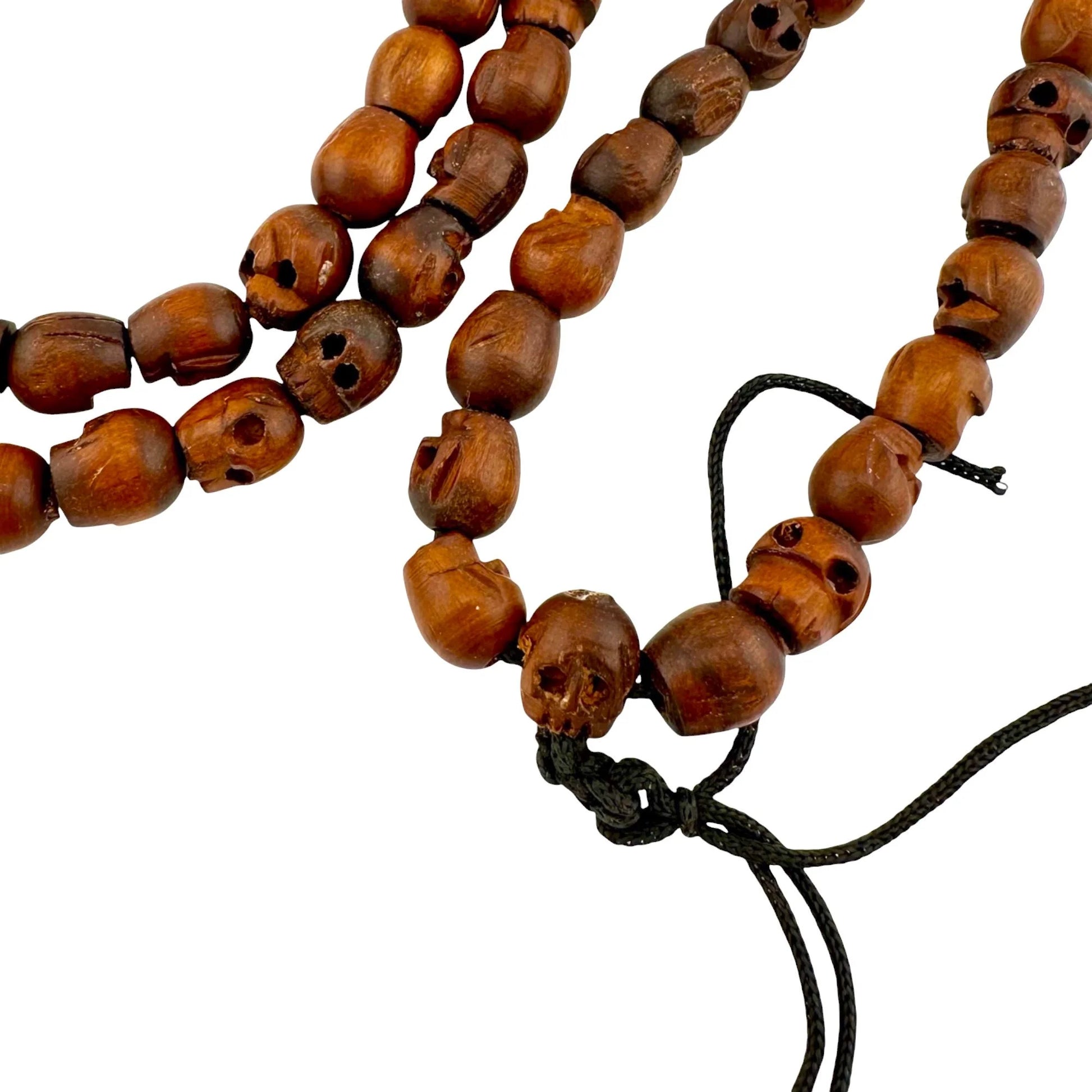 Wooden handmade beaded skull necklace with a tassel on a white background