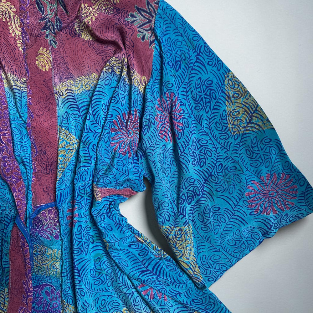 Colorful patterned fabric with blue and pink tones on a white background