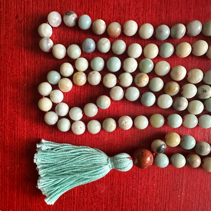 handmade mala beaded necklace with aqua tassel and brown guru bead