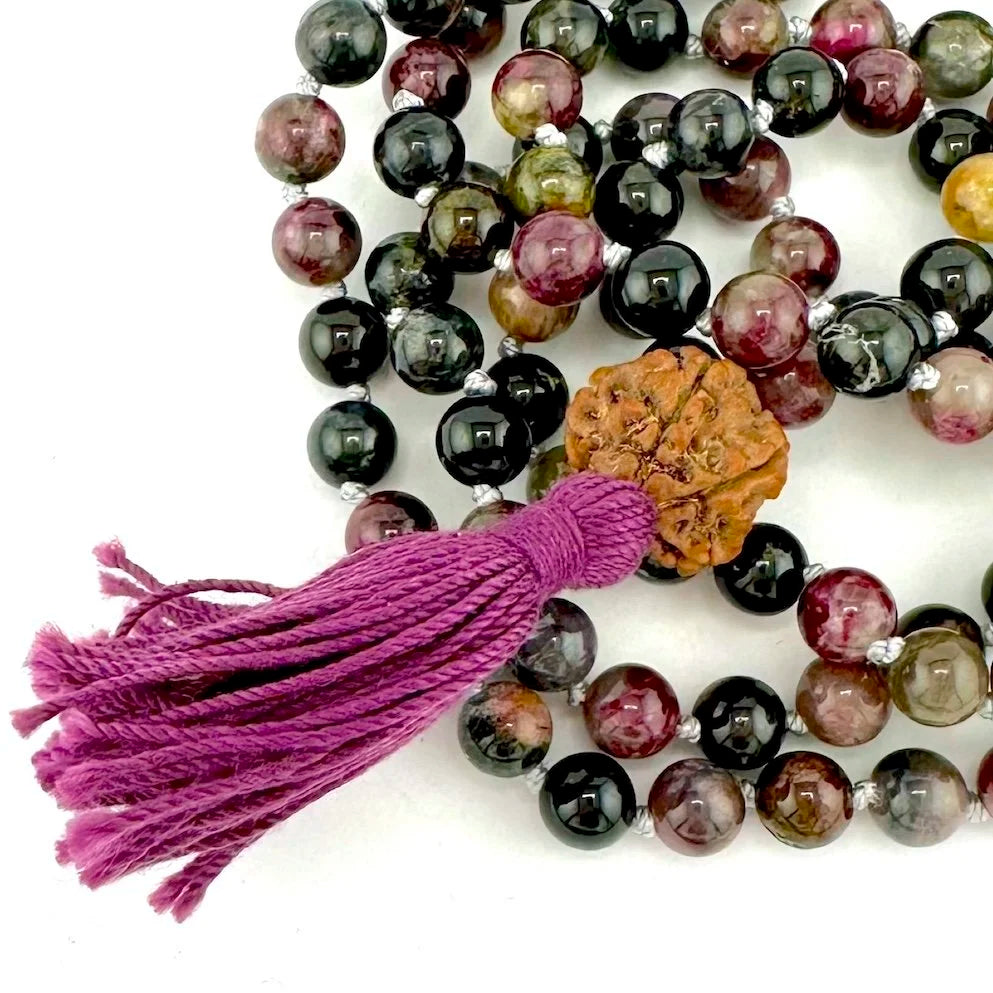 Multicolored beaded tourmaline mala necklace with a tassel on a white background