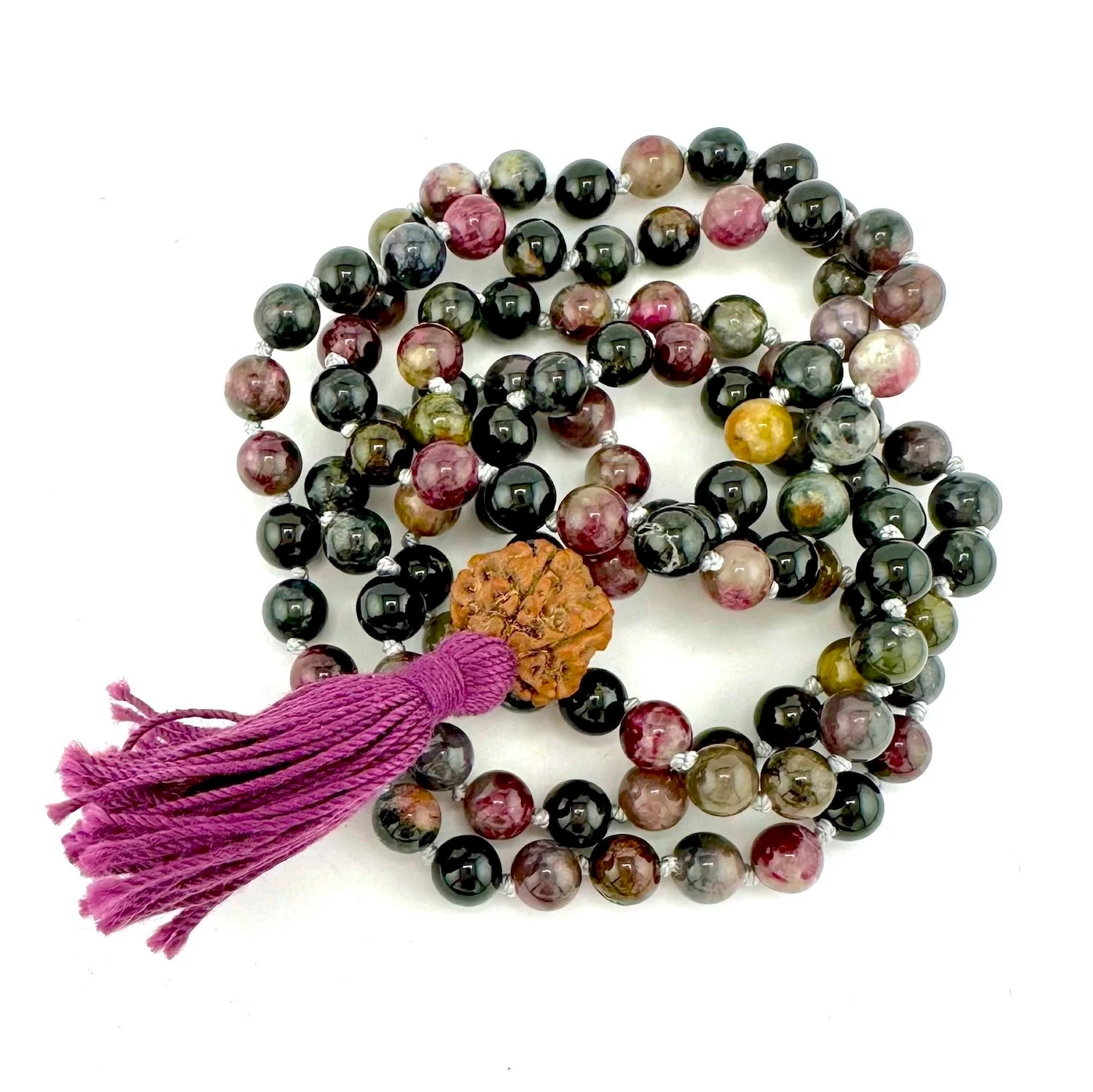Multicolored beaded tourmaline mala necklace with a tassel on a white background