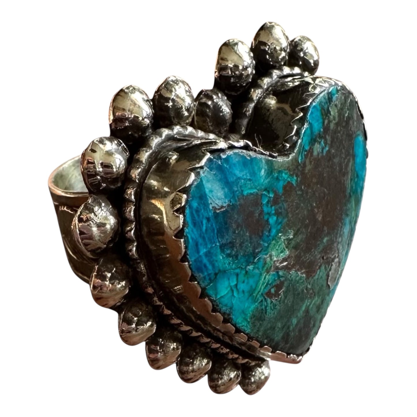 Turquoise chrysocolla stone ring with silver and gold accents on a white background