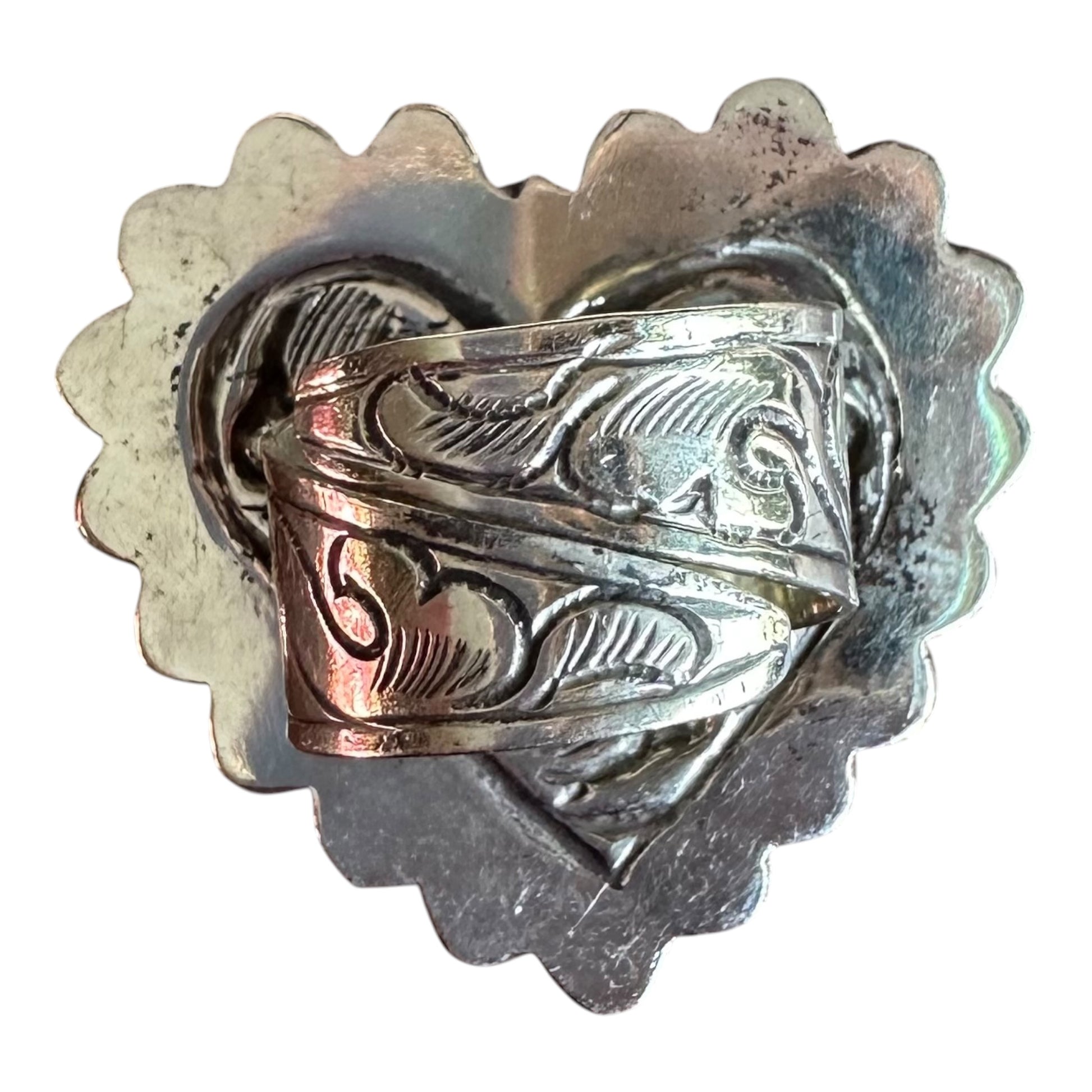 Back of Silver ring with hand tooled intricate designs on a white background