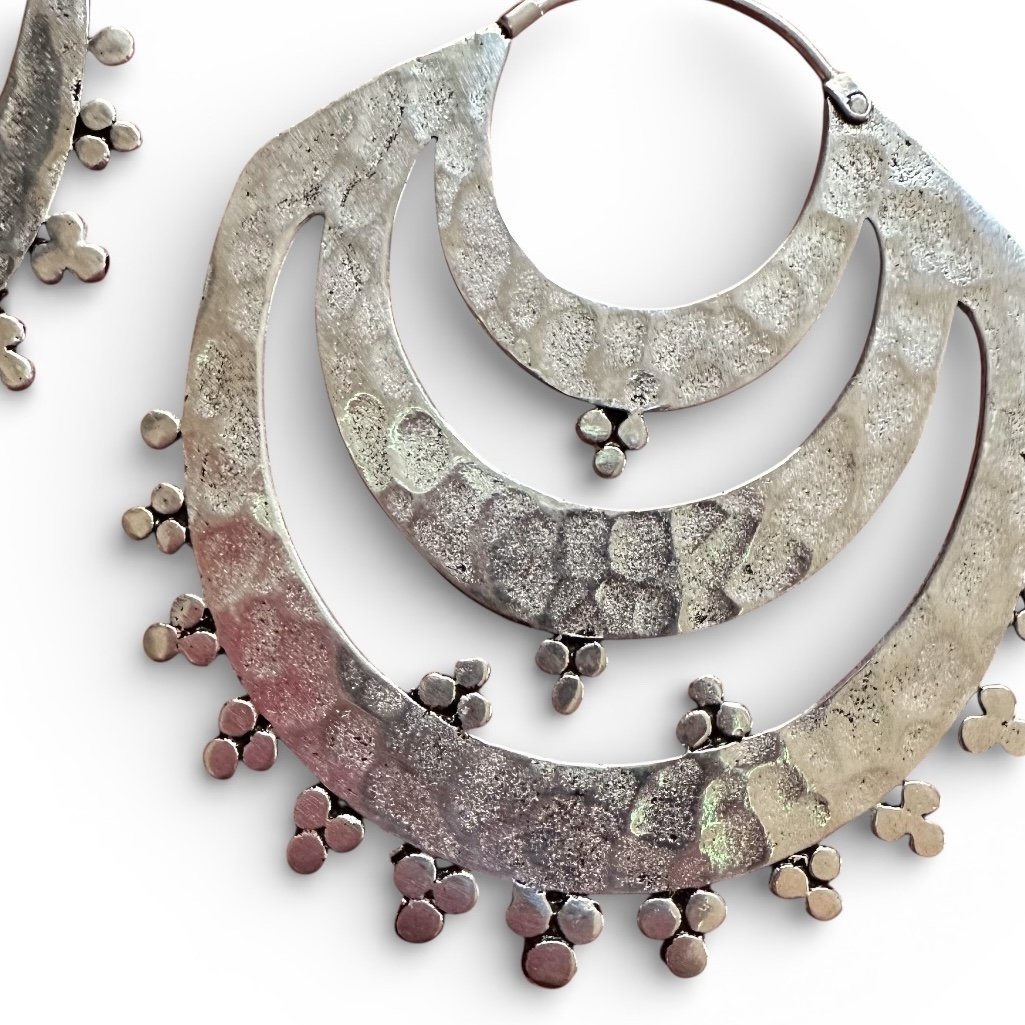 Indonesian tribal hoop earrings with triple half moon shape on white background
